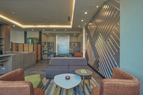 a living room with two couches and a table at Somerset Millennium Makati in Manila