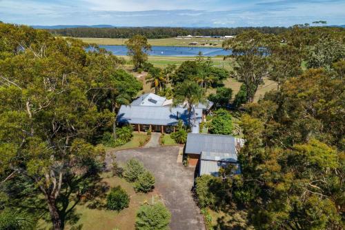 an aerial view of a house in the trees at Tulloch Estate in Tuncurry