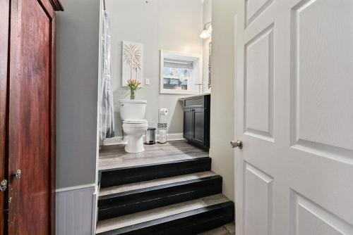 a bathroom with a toilet and stairs in a room at Country Style Home 4br 2bth in Brewer