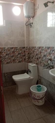 a bathroom with a toilet and a sink at Hotel Ram Way in Visakhapatnam