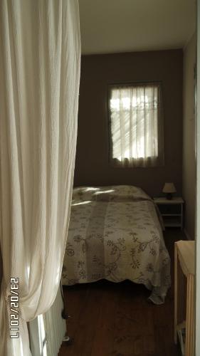 a bedroom with a bed with a white curtain at Mas Grimaud - Gîte- Studio et chambres d'hôtes familiales in Eygalières