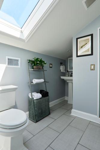 a bathroom with a toilet and a skylight at Downtown Savannah Oasis in Savannah