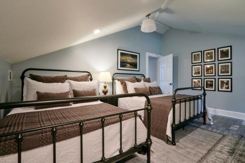a bedroom with two beds and a blue wall at Downtown Savannah Oasis in Savannah