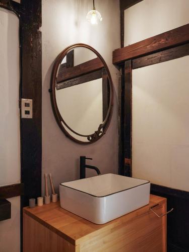 a bathroom with a white sink and a mirror at 眠ル庭ーnemuruniwa in Tochigi