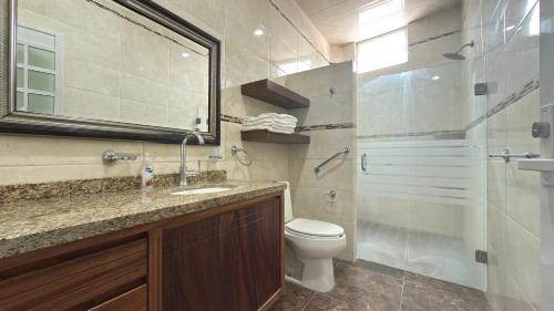 a bathroom with a toilet and a sink and a shower at Bungalows Mufrance in San Patricio Melaque