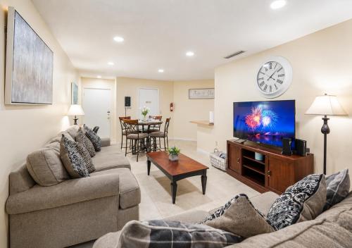 a living room with two couches and a flat screen tv at 3608 Orlando Vacational 1st floor in Orlando