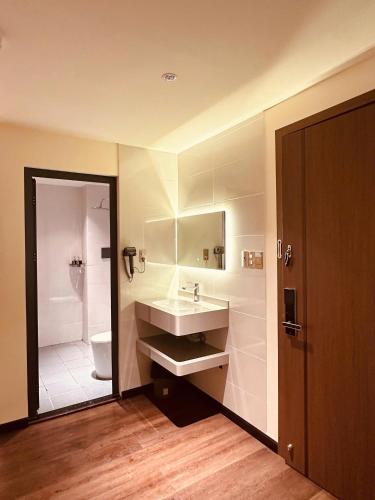 a bathroom with a sink and a toilet at The Cloud Hotel Bình Dương in Ga Phú Trung