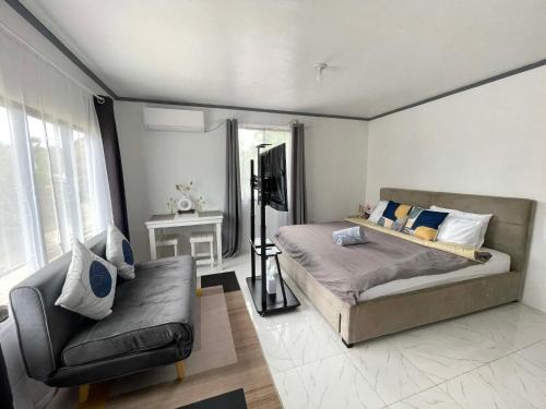 a bedroom with a bed and a couch at CJ cozy tiny home in Santa Barbara