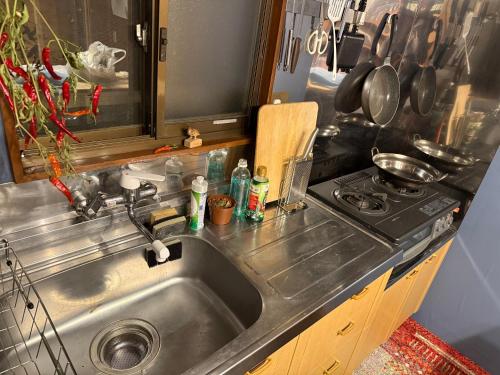 a kitchen with a sink and a stove at Hakushu hutte in Hokuto