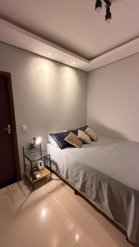 a bedroom with a bed in a room at Cozy house with pool in Campo Grande