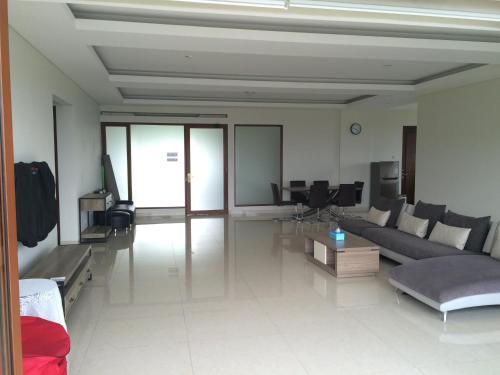 a living room with a couch and a table at Roemah Asri Villa - Resor Dago Pakar in Bandung