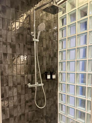 a shower with a shower head in a bathroom at Angela Stay in Pattaya