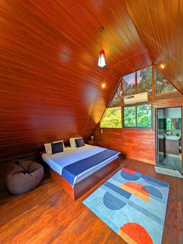 a bedroom with a bed in a wooden wall at Green Breeze Villa in Katugastota