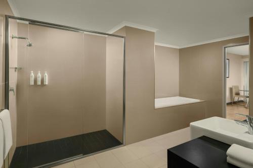a bathroom with a shower and a sink at Courtyard by Marriott Darwin in Darwin