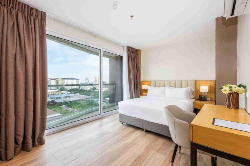 a hotel room with a bed and a large window at Citi Park Hotel Cebu powered by Cocotel in Cebu City