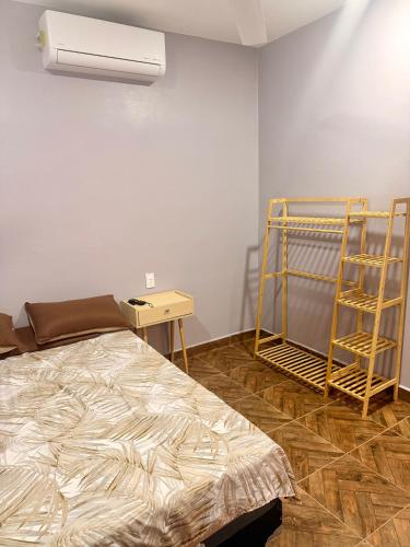 a room with a bed and a fan and a table at Casa Zapata in Chano
