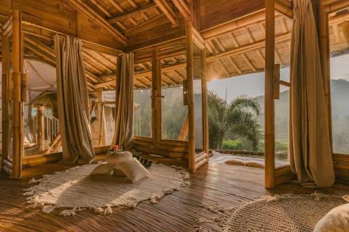 a large wooden room with a large rug on the floor at Bamboo amazing villa sidemen in Selat