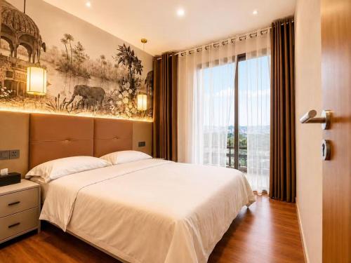 a bedroom with a large bed and a large window at Axis Residences Apartment in Phnom Penh