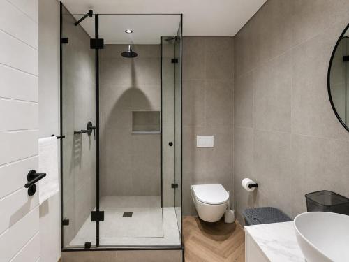 a bathroom with a shower and a toilet and a sink at 410 On Park in Cape Town