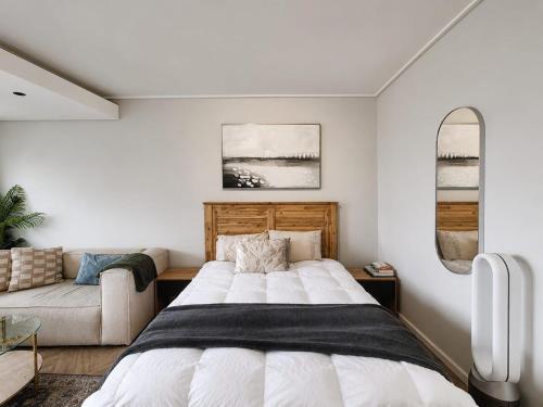 a bedroom with a large bed and a couch at 410 On Park in Cape Town