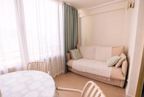 a small living room with a couch and a window at Alma de Mar in Finestrat