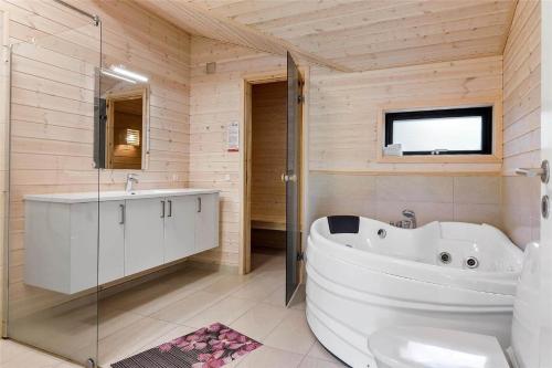 a bathroom with a large tub and a sink at 0410-Romo-Strandskaden-15 in Høm