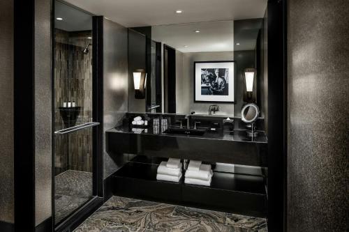 a bathroom with a sink and a mirror at BISHA, a Luxury Collection Hotel, Toronto in Toronto