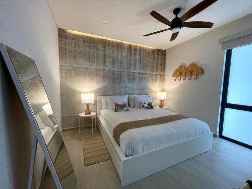 a bedroom with a bed and a ceiling fan at Wabi Sabi in Rosarito