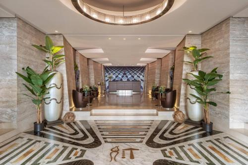 a lobby of a hotel with plants on the walls at Meliá Genova in Genoa