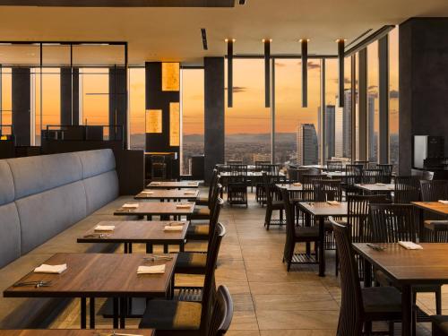 a restaurant with tables and chairs and a view at Nagoya Prince Hotel Sky Tower in Nagoya