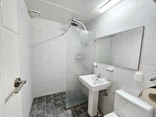 a bathroom with a sink and a toilet and a mirror at Jeju Lavender Hotel in Seogwipo