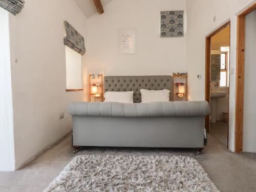 a bedroom with a large bed in a room at Wern Olau Cottage in Caernarfon