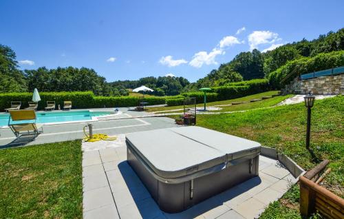 a bed on a patio next to a swimming pool at Oasi Di Cocciola in Badia Tedalda