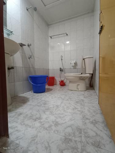 a bathroom with a toilet and a sink and a tub at Hotel Green Land in Bāndarban