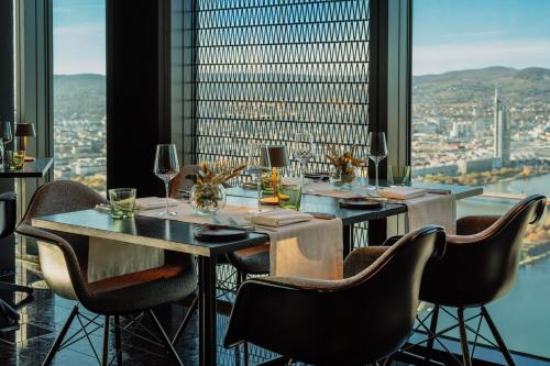a dining room with a table and chairs and a window at Meliá Vienna in Vienna