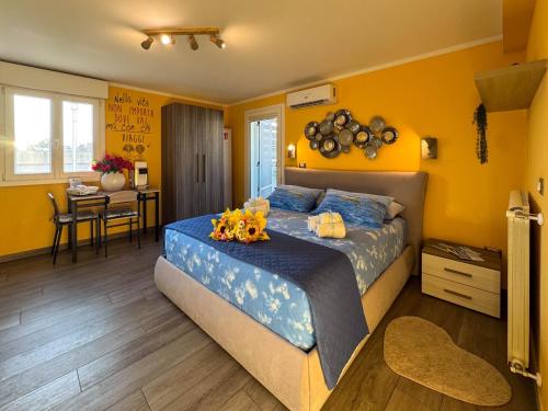 a bedroom with a large bed and a dining room at Il Panoramico - Terrazza e Jacuzzi in Neviano