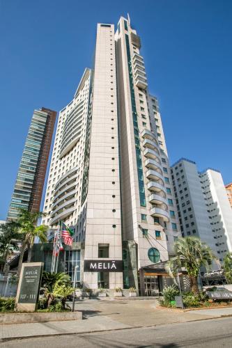 a large building with a mella sign in front of it at Meliá Jardim Europa in São Paulo