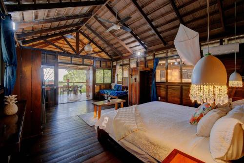 a bedroom with a large bed in a house at Villas Serenidad in Puerto Viejo