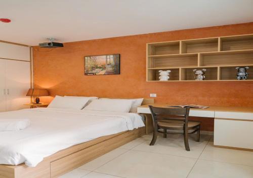 a bedroom with a bed and a desk and a chair at BOHO Homestay Hanoi - No81 Alley 8 Ton That Thiep in Hanoi