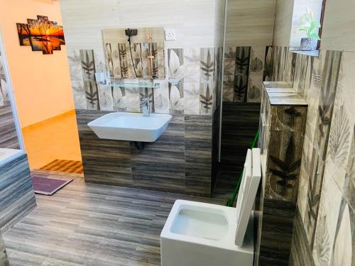 a bathroom with a sink and a toilet at willow Blossoms in Pannipitiya