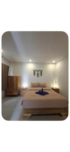 a bedroom with a large bed in a room at Join Homestay in Kuta Lombok