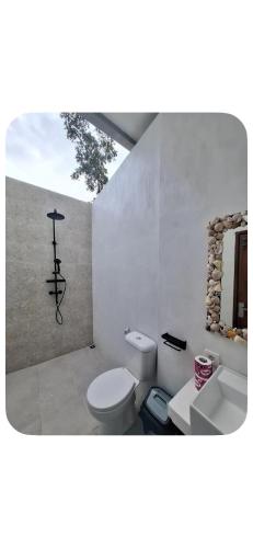 a bathroom with a toilet and a sink at Join Homestay in Kuta Lombok