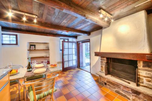 a kitchen with a fireplace and a table and chairs at Rustico Caterina - Corippo- Happy Rentals in Corippo