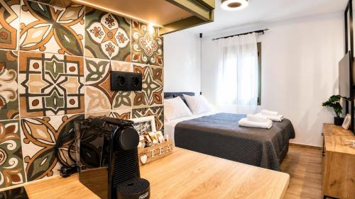 a bedroom with a bed and a tv in a room at Elaia & Nyx Residence in Volos