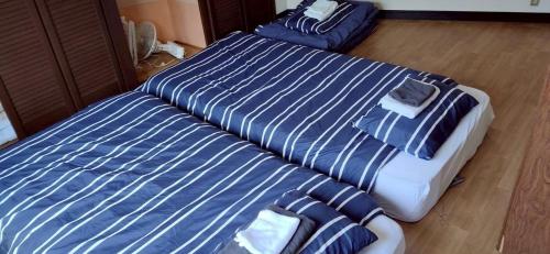 two beds sitting next to each other in a bedroom at TRIANGLEosaka in Osaka