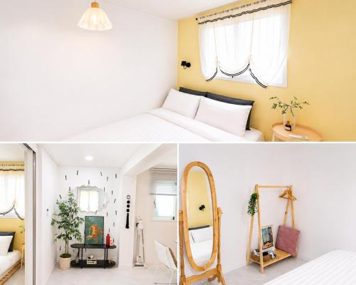 a bedroom with a white bed and a mirror at Woori Stay in Suwon