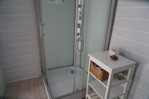 a shower in a bathroom with a white table at Casa 9 in Sfântu Gheorghe