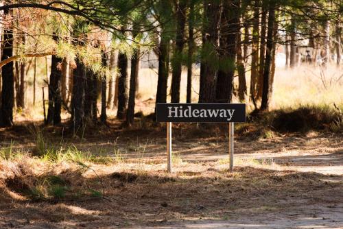 a street sign in the middle of a forest at The Hideaway at Novena Pines by Tiny Away in Thulimbah