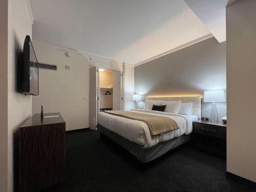 a hotel room with a large bed and a television at Ahern Hotel and Event Center in Las Vegas