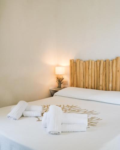 two beds in a room with towels on them at Amoreddu in San Teodoro